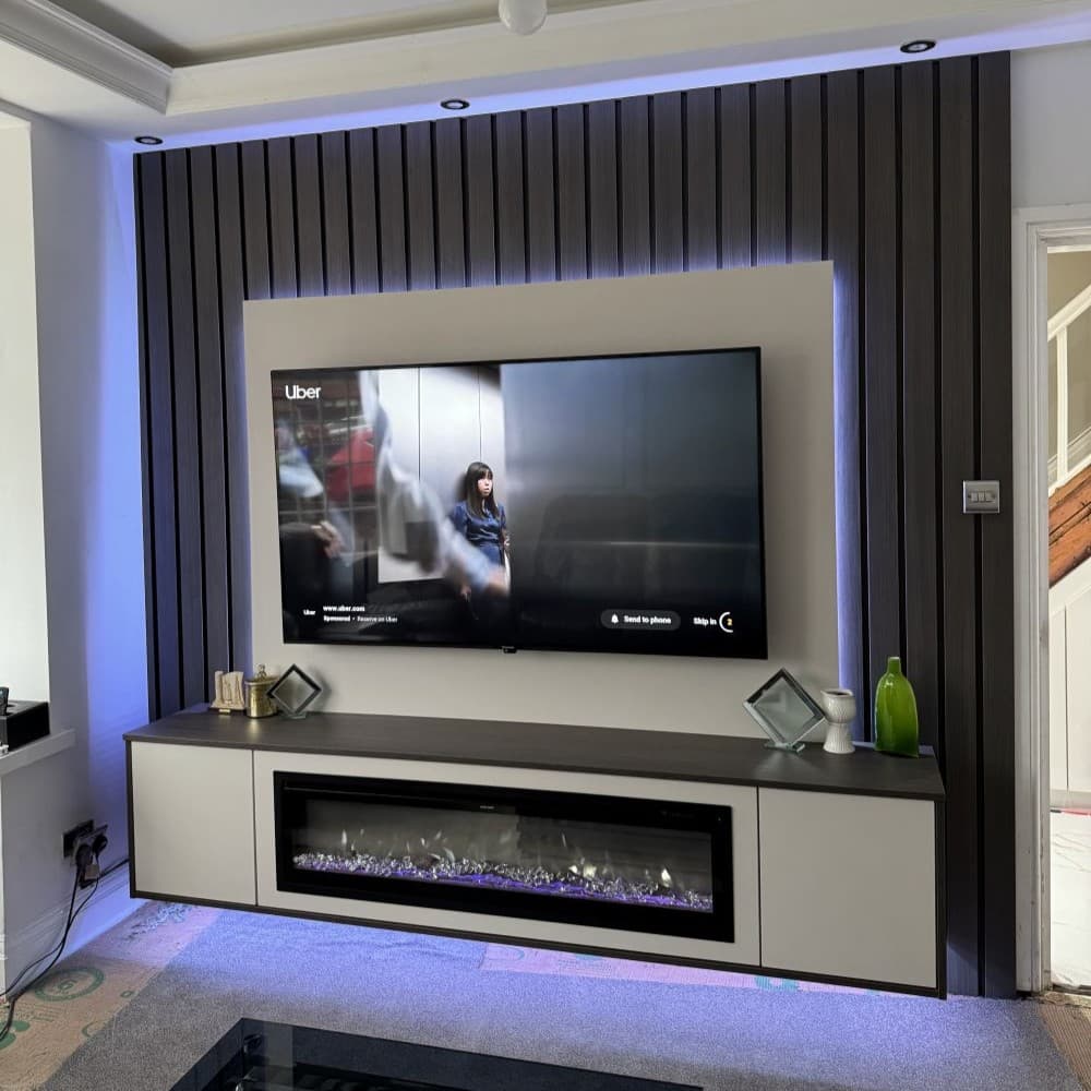 Custom TV unit with integrated shelves and drawers built into living room wall