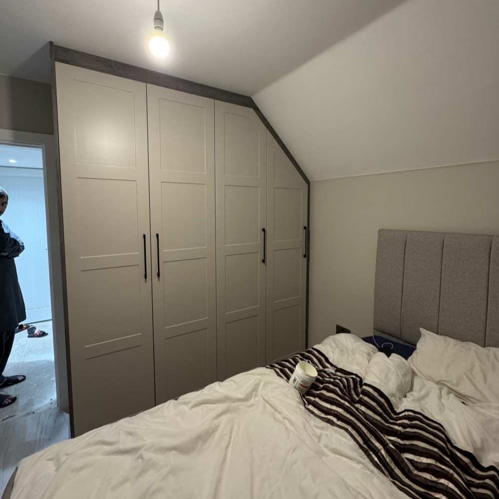 Ceiling-high bespoke fitted wardrobe with shaker-style white doors