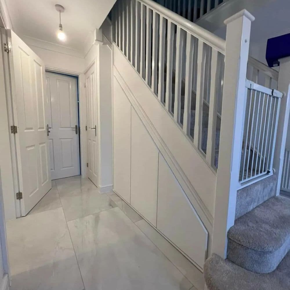Tailor-made drawers and cabinets built beneath stairs for efficient storage use