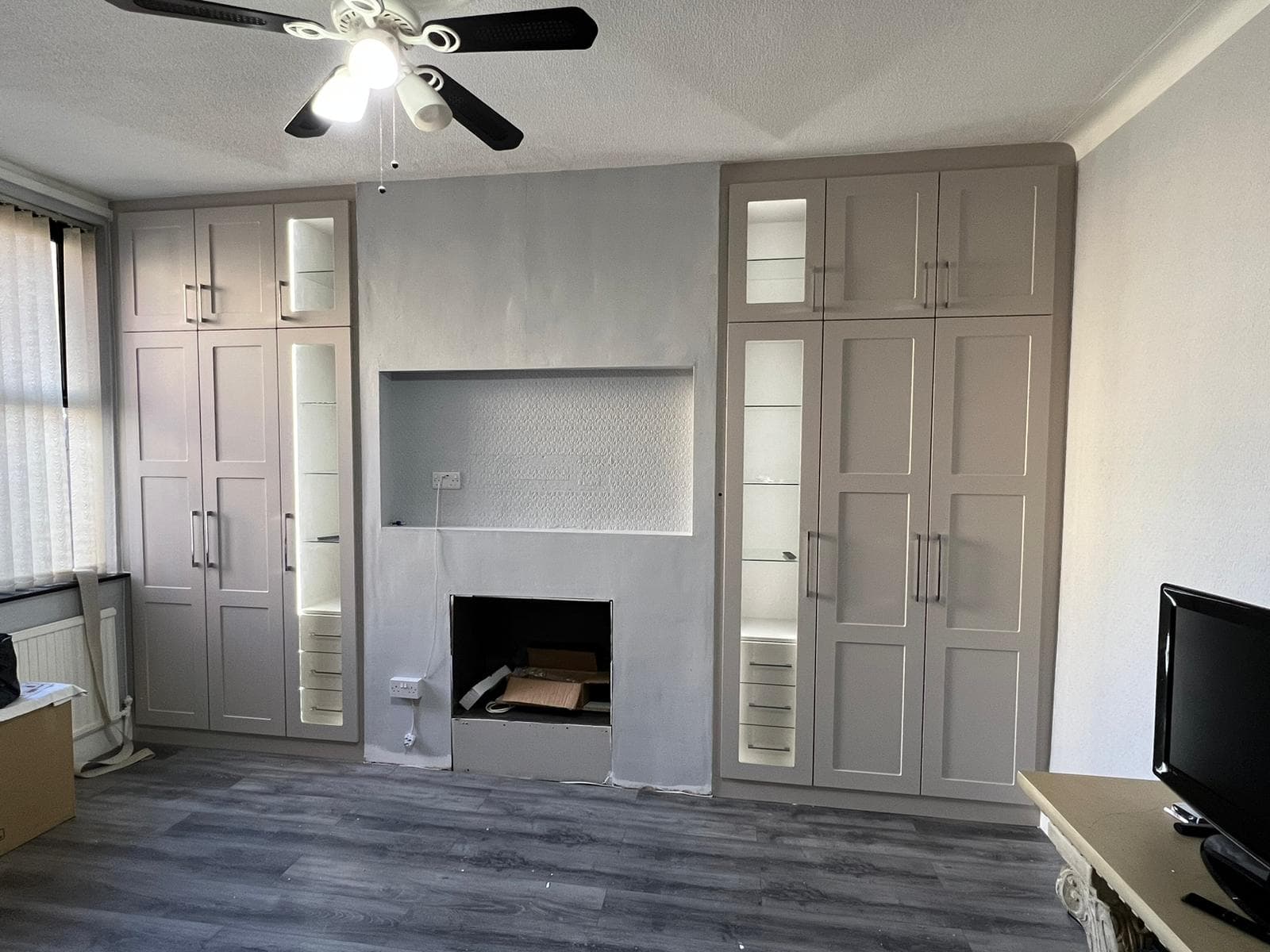 Bespoke fitted table harmonising with fitted wardrobes in a Manchester home