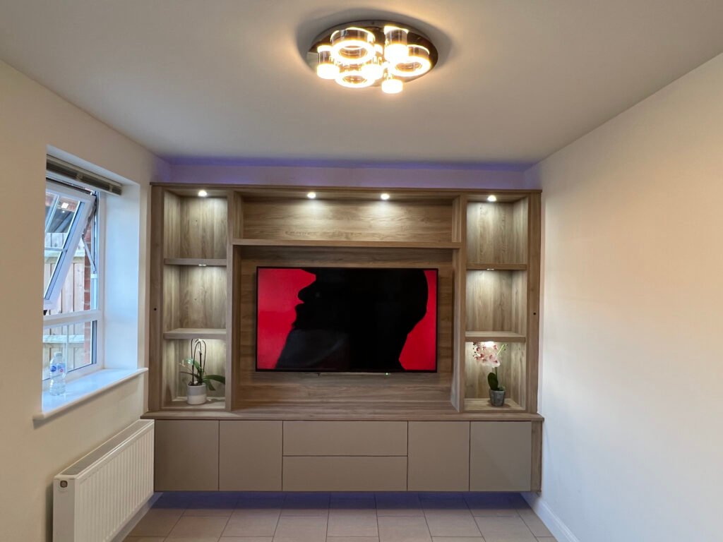 Contemporary multimedia cupboard with integrated TV, spotlight shelving, and wood panel finish in a stylish living room.